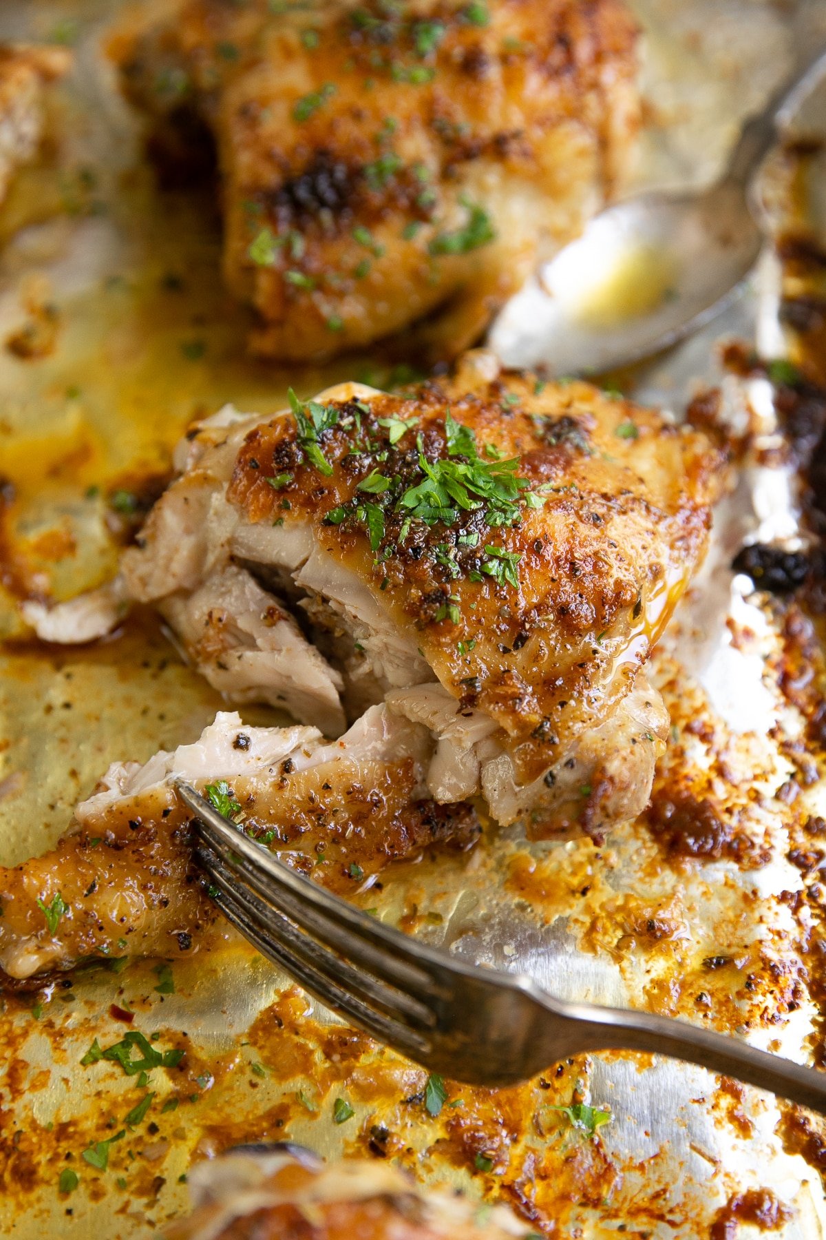 Baked garlic Chicken thighs on a large baking sheet.