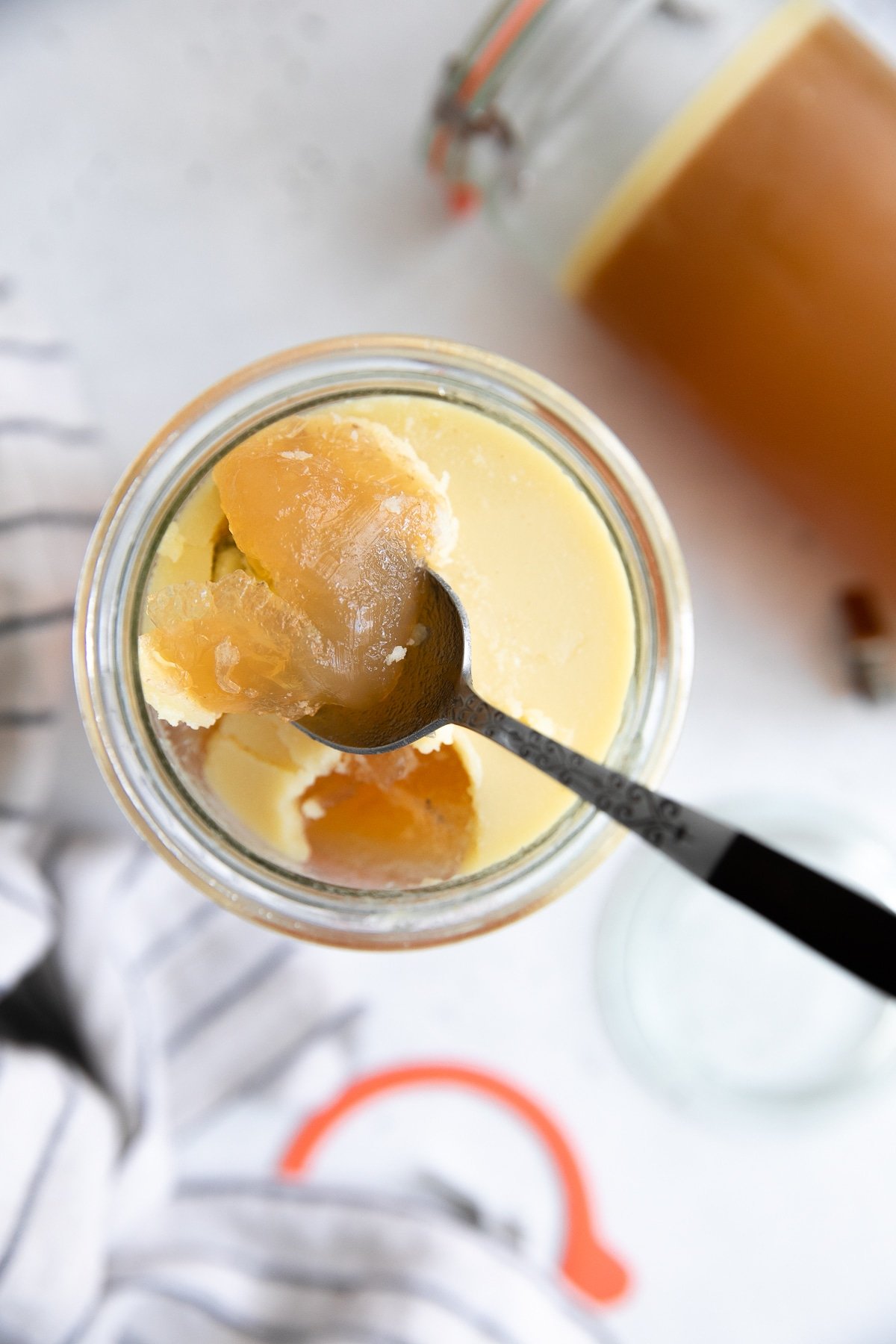 Spoon scooping out gelled bone broth made in the Instant Pot..