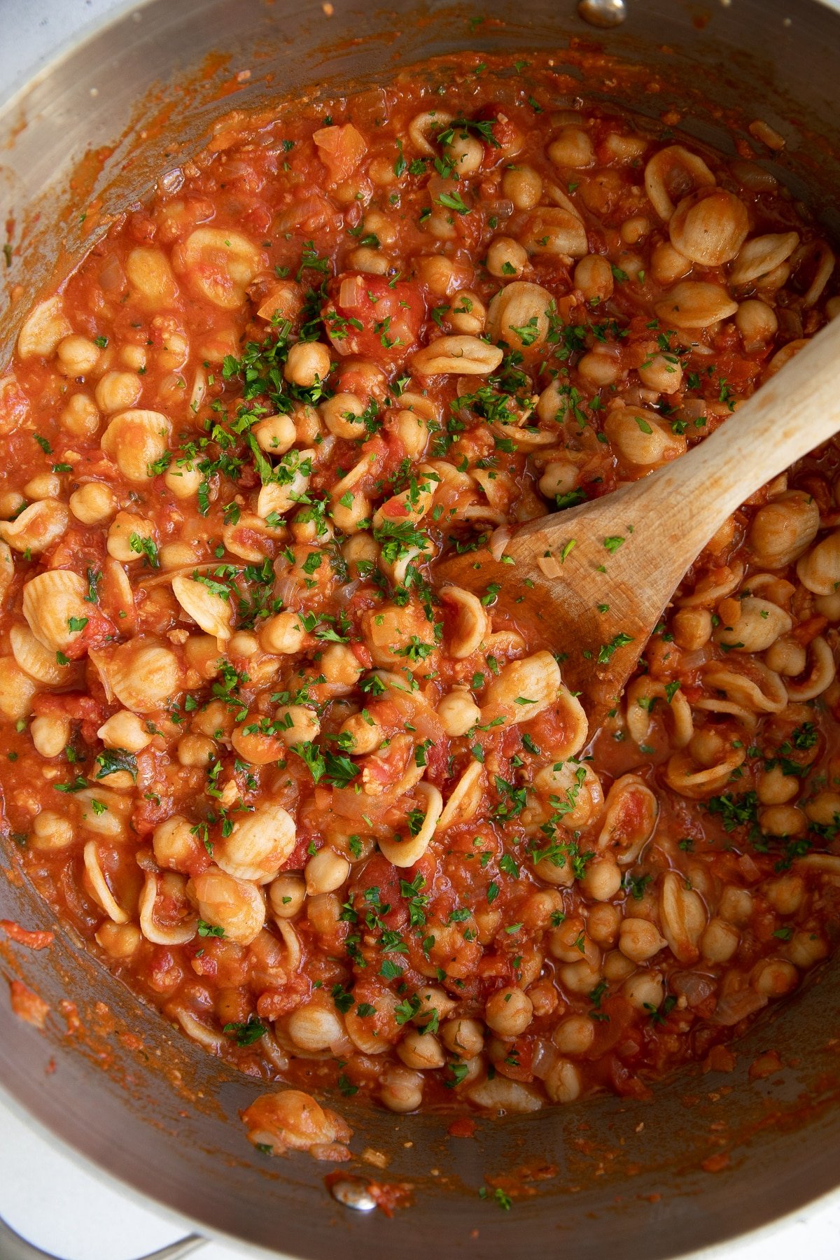 Large pot filled with pasta and chicken peas in a tomato sauce made with fresh tomatoes, onion, and pancetta.