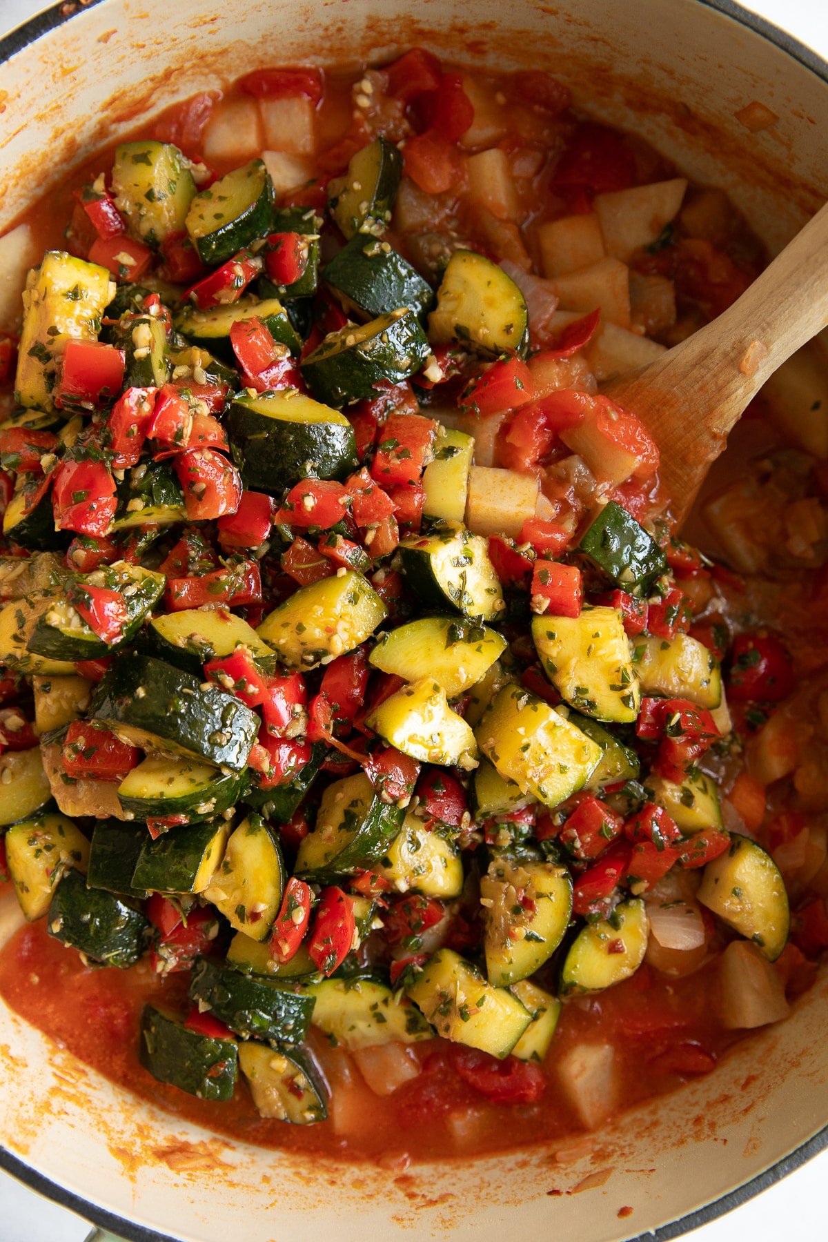 Slow cooked potatoes and tomatoes topped with sauteed vegetables coated in pestata made from olive oil, basil, oregano, garlic, and red chili flakes.