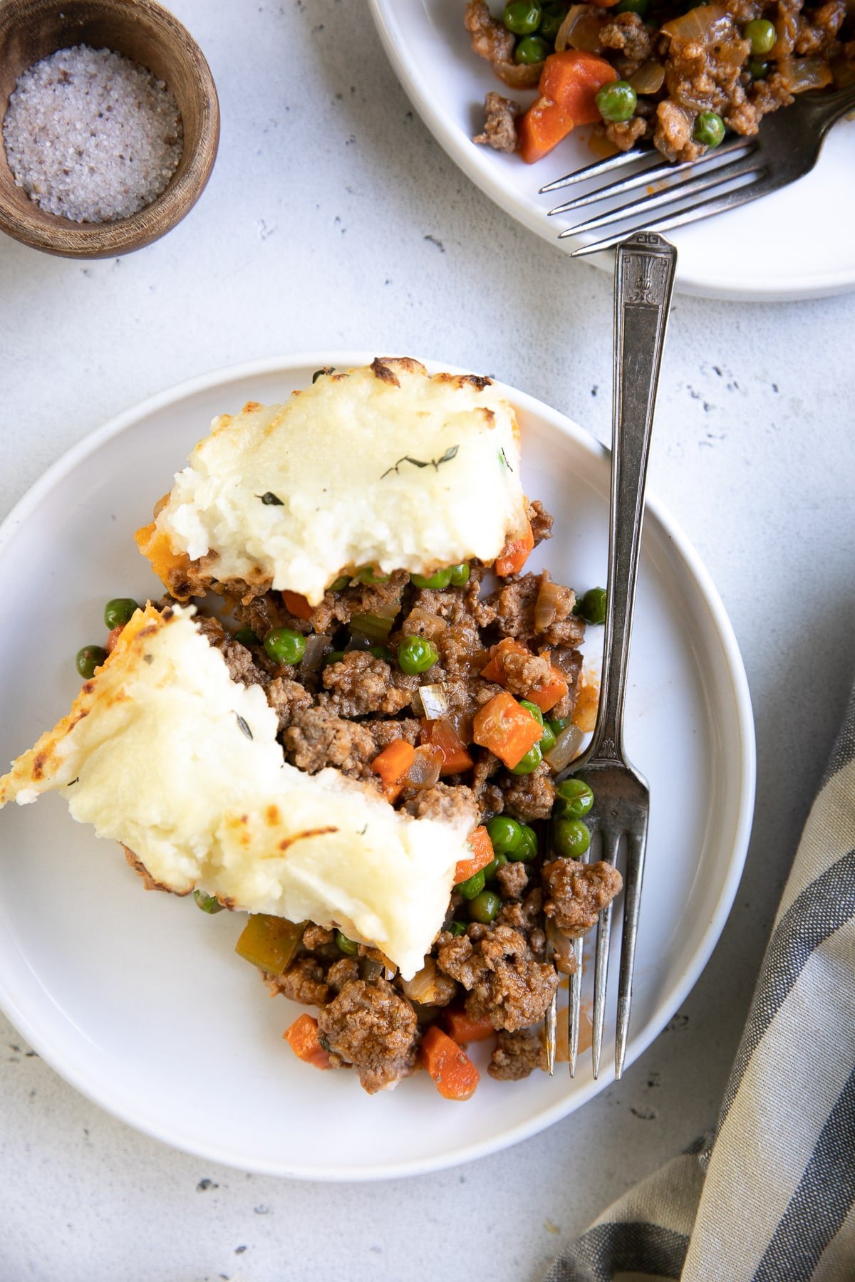 Big slice of homemade classic shepherd's pie on a white serving plate.