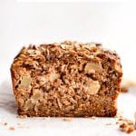 Vertical Pinterest image showing a sliced loaf of apple cinnamon bread with text above reading APPLE BREAD with rolled oats, cinnamon, and applesauce and The Forked Spoon below.
