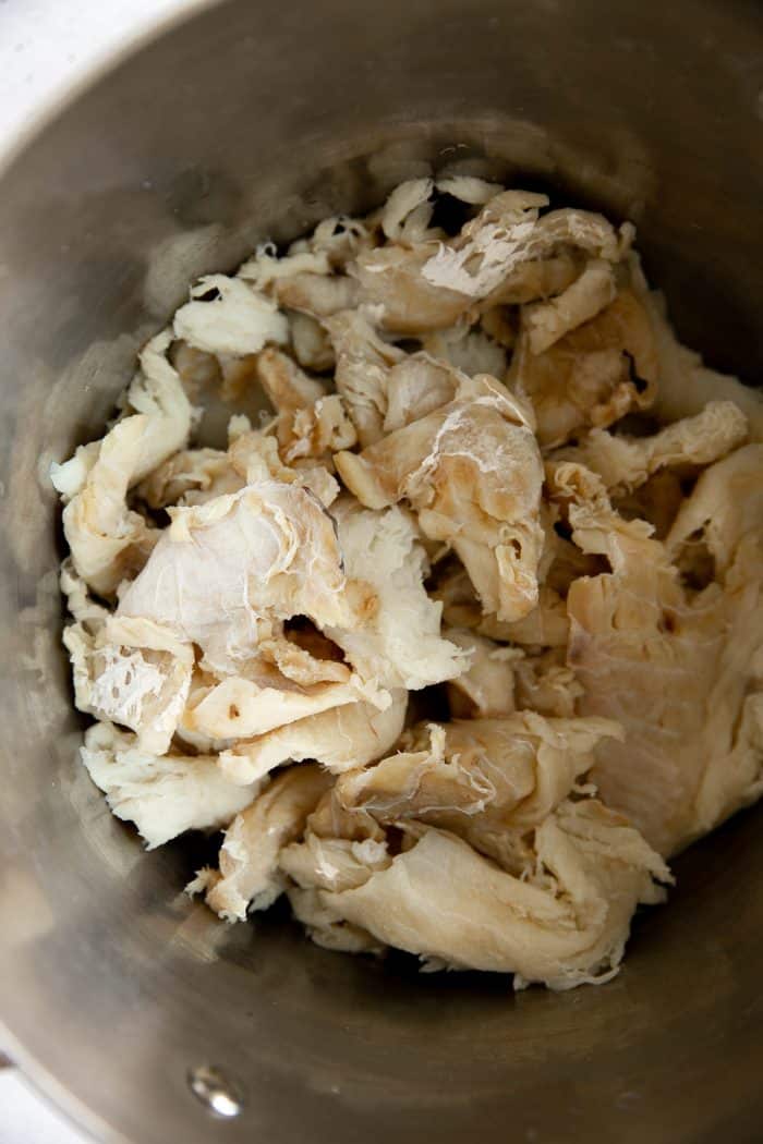 Large pot filled with soaked dried and salted cod.