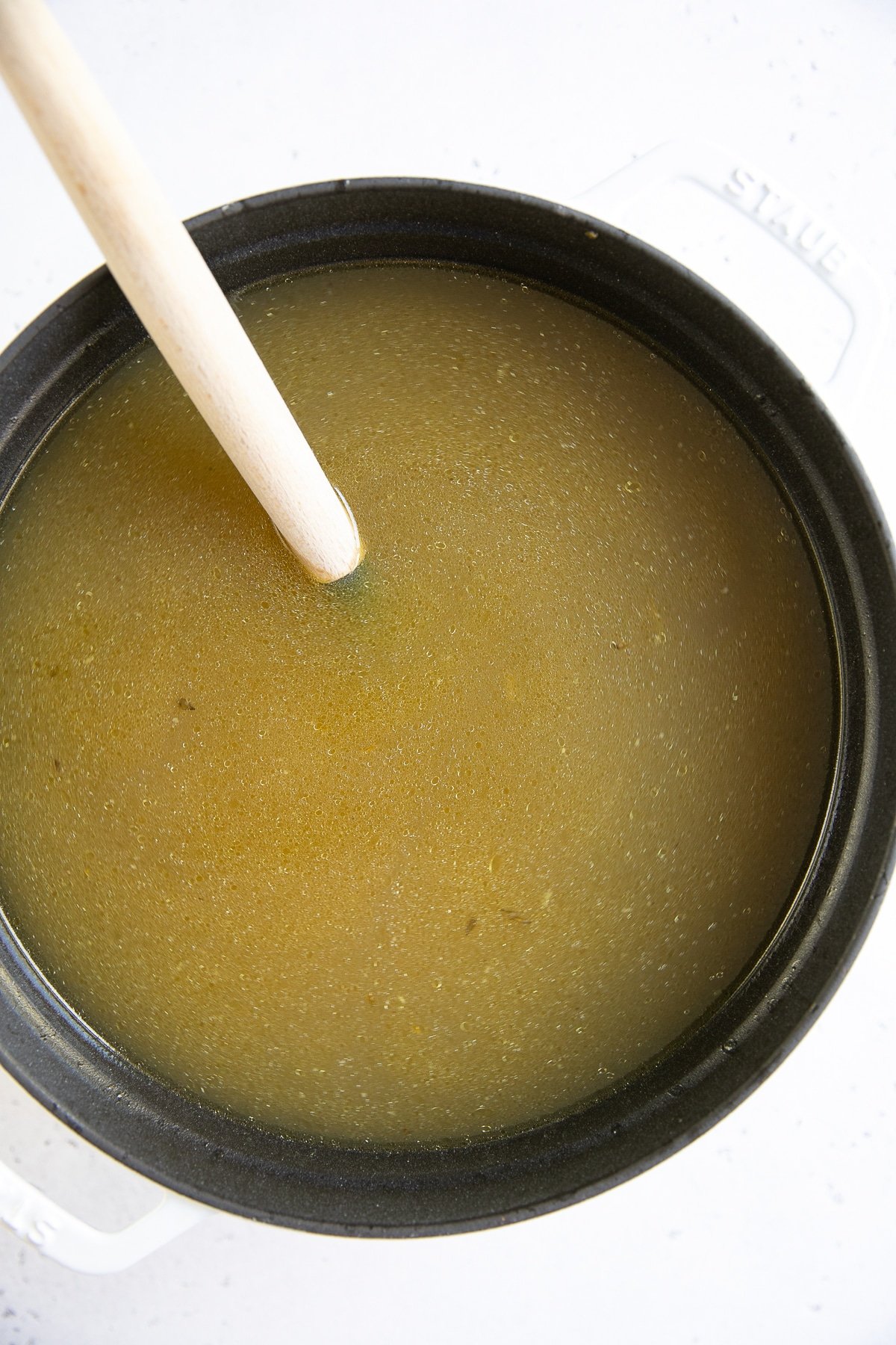 Large pot filled with homemade chicken stock.