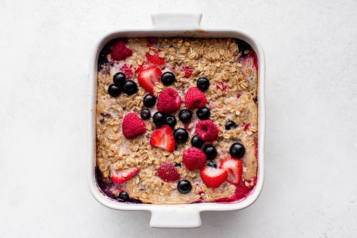 Golden baked oatmeal with juicy berries showing through the top