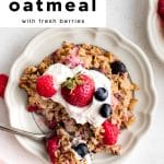 Plate of baked oatmeal topped with yogurt, strawberries, raspberries, and blueberries with text overlay โmake-ahead friendly baked oatmeal with fresh berries.โ