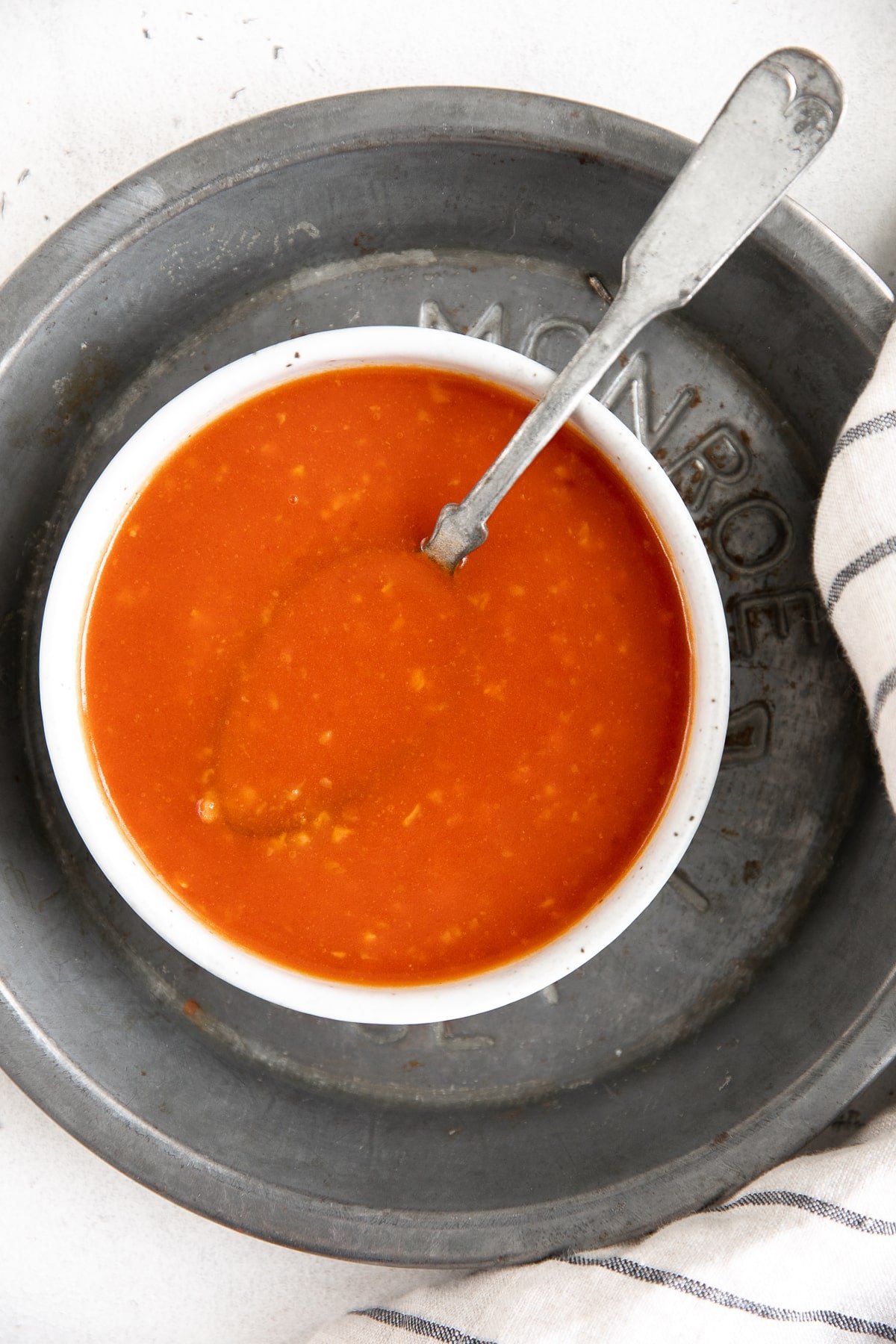 White bowl filled with homemade buffalo sauce.