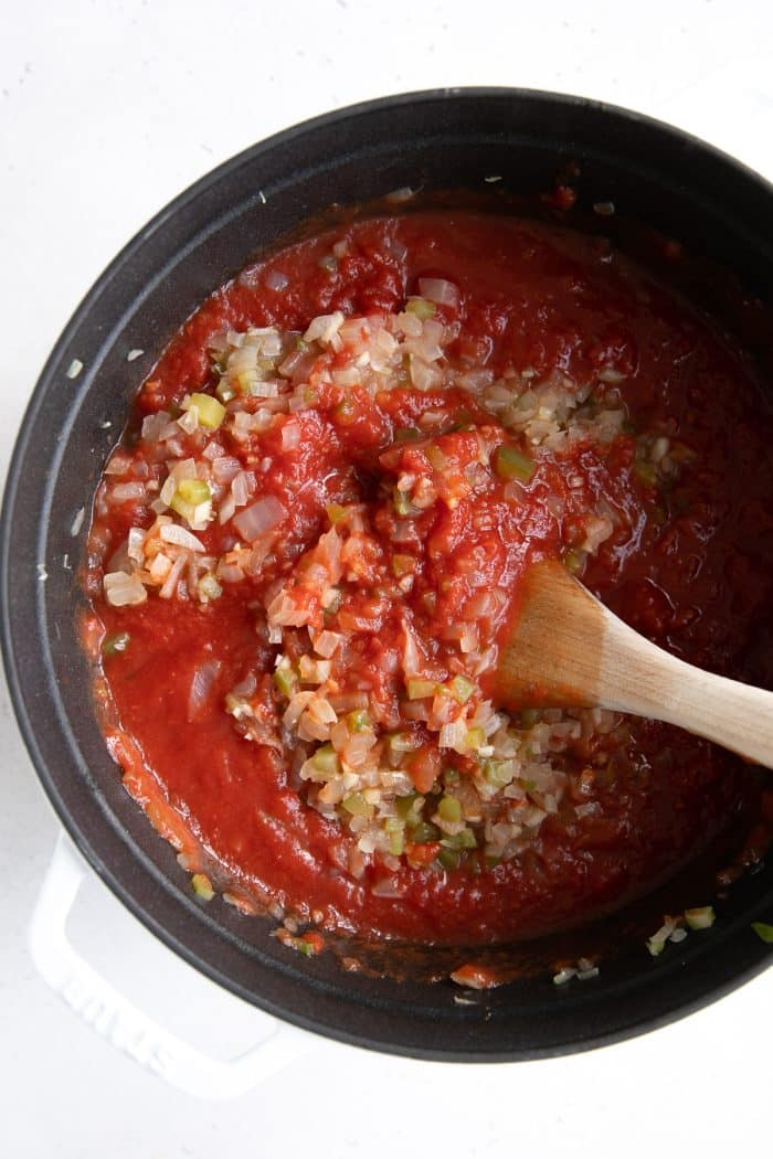 Large saucepan filled with onion and garlic tomato sauce