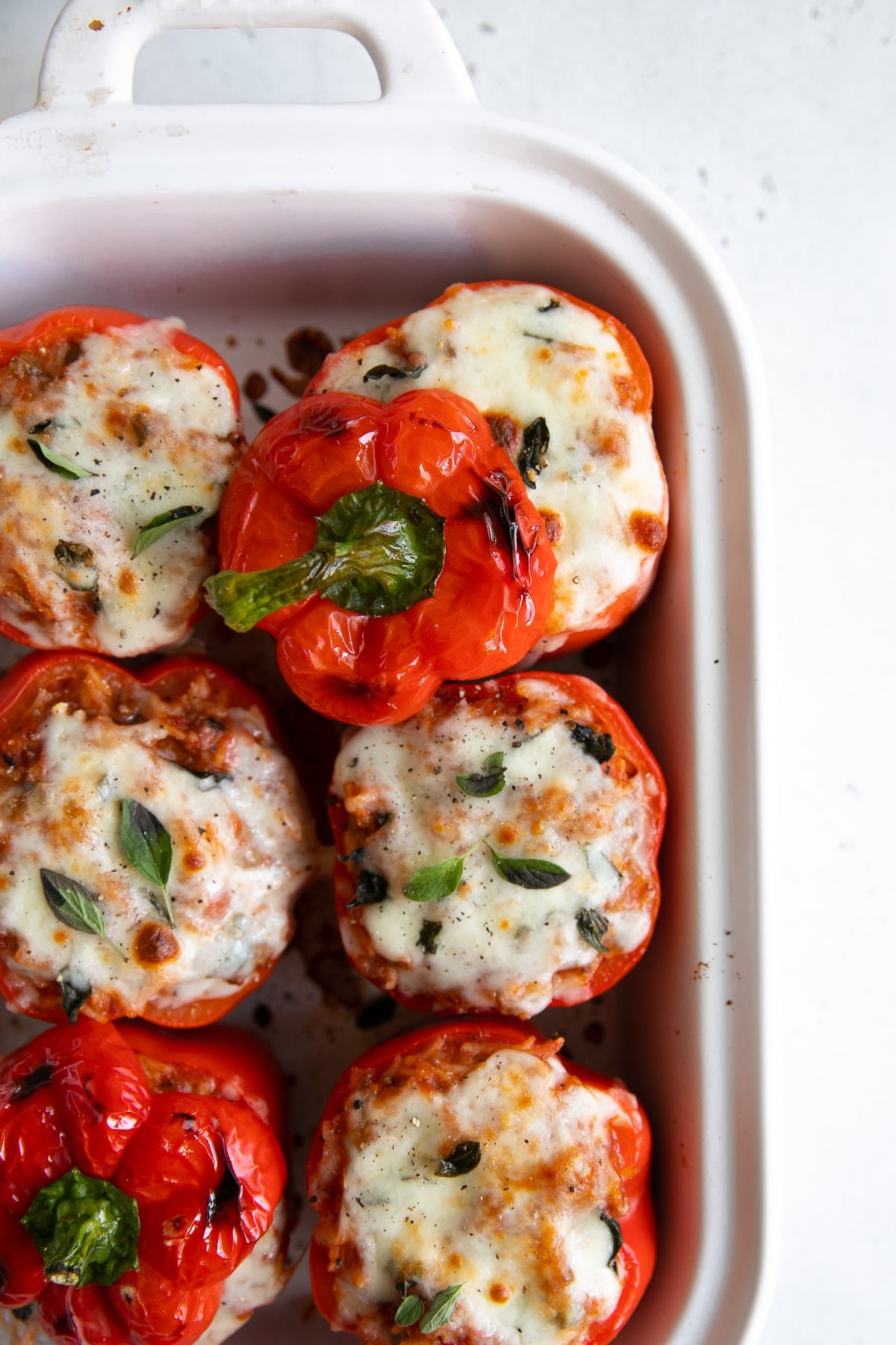 Stuffed and baked red bell peppers topped with mozzarella cheese and fresh oregano.