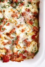 Stuffed shells baked with tomato sauce and mozzarella cheese in a baking dish.