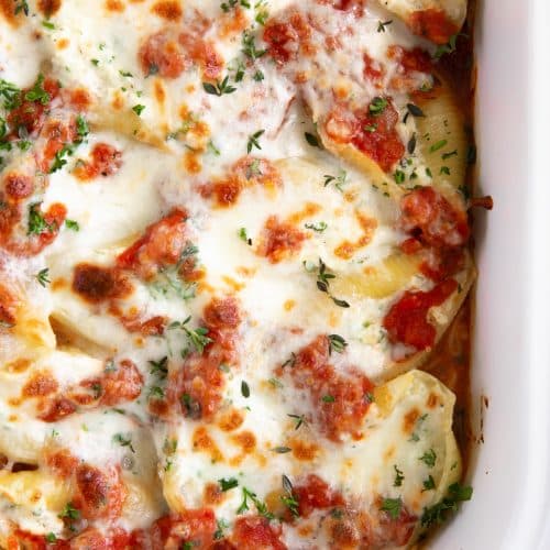 Stuffed shells baked with tomato sauce and mozzarella cheese in a baking dish.