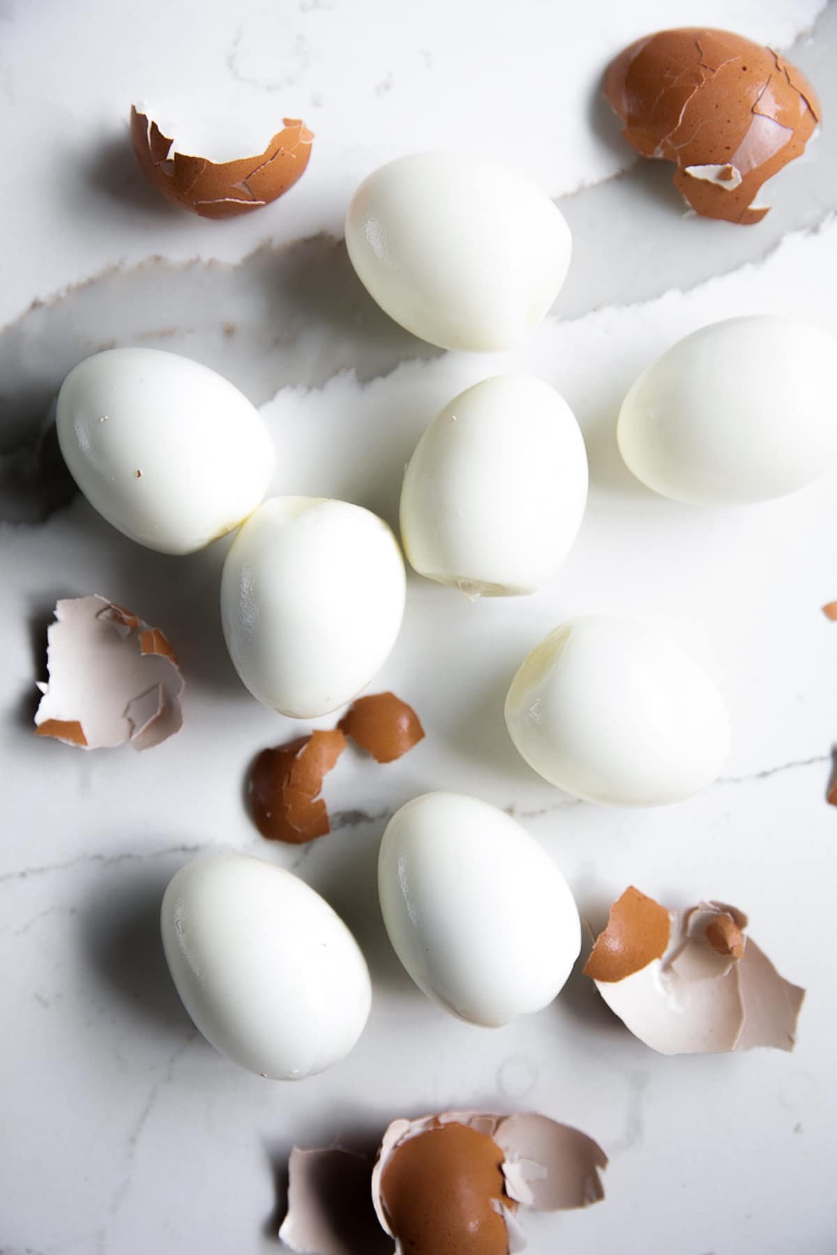 Eight perfectly peeled hard boiled eggs without shells.