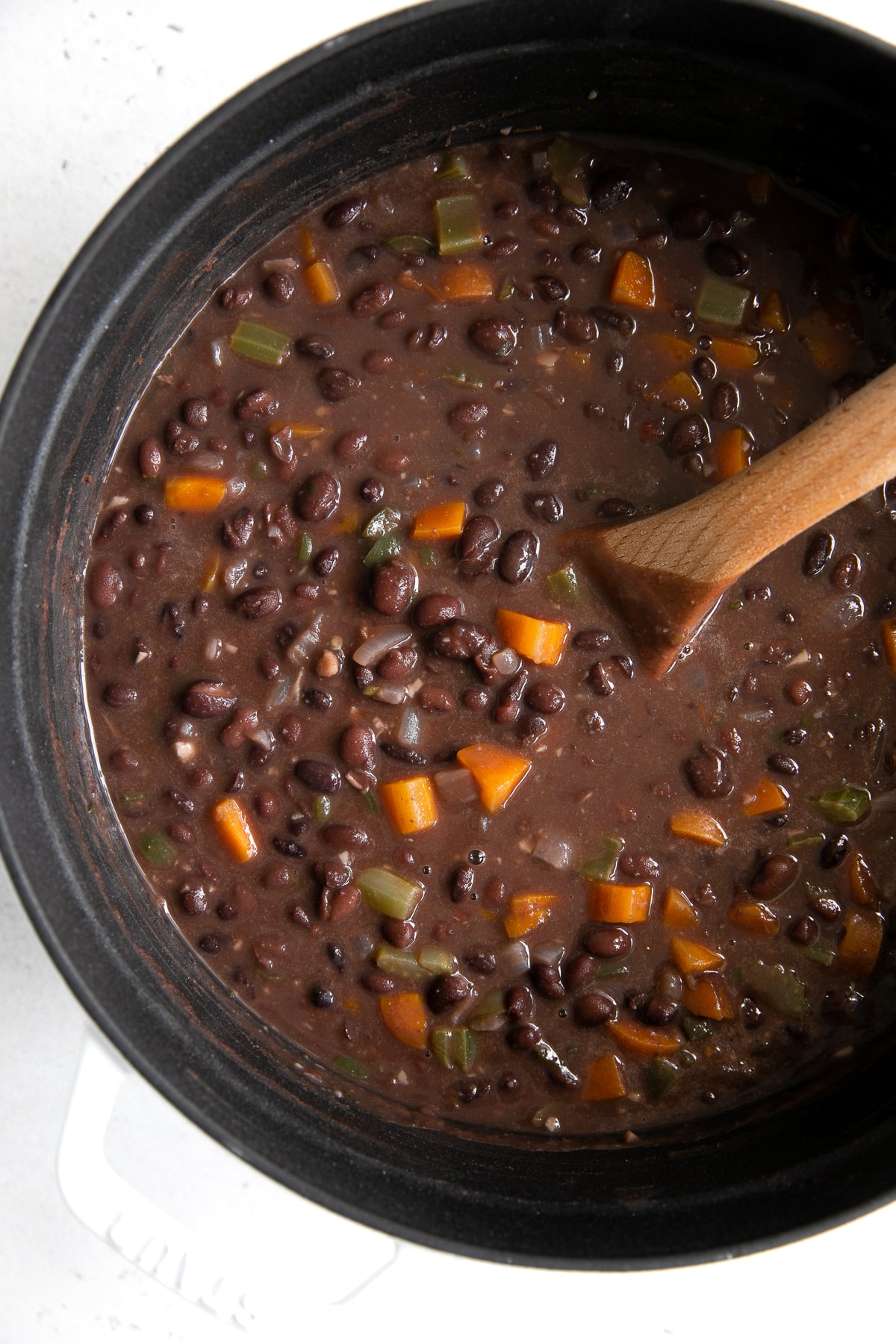 Large pot filled with simmering black bean soup.