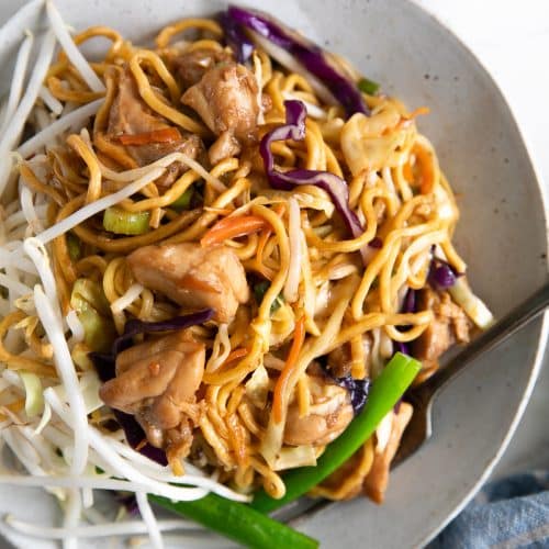 Large white plate filled with chicken and vegetable chow mein.