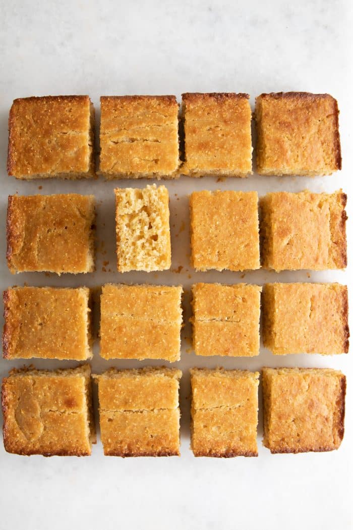 Pan of freshly baked cornbread removed from the pan and sliced into cubes.