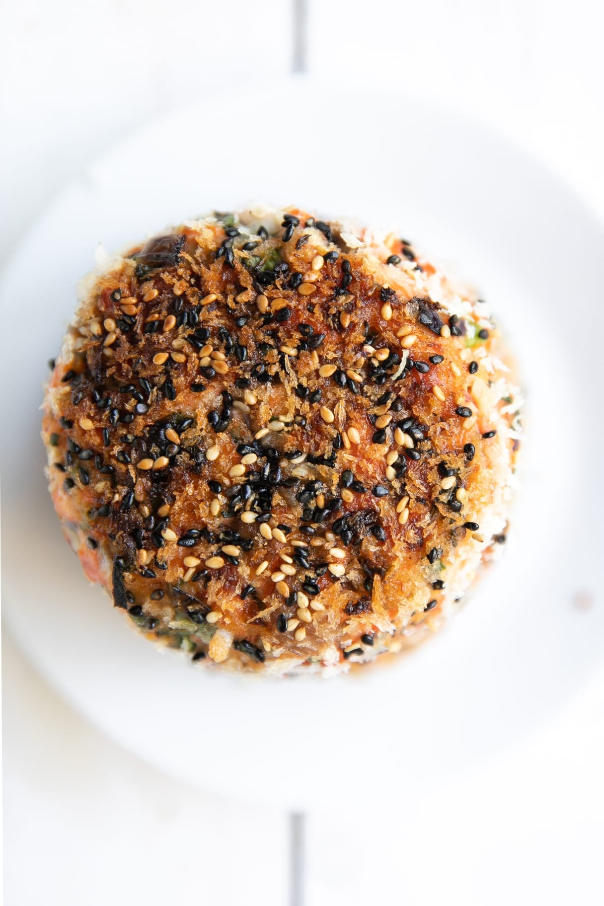 Fully cooked sesame crusted salmon patty.
