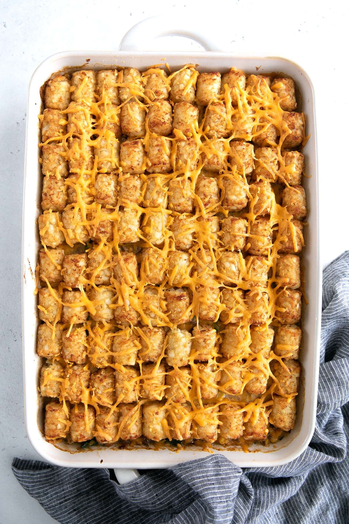 Baked tater tot casserole in a large baking dish.