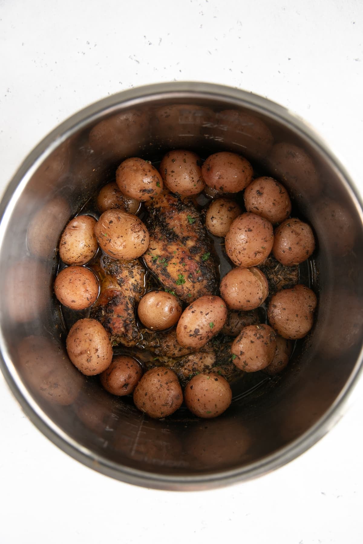Fully cooked chicken breasts and potatoes in an Instant Pot.