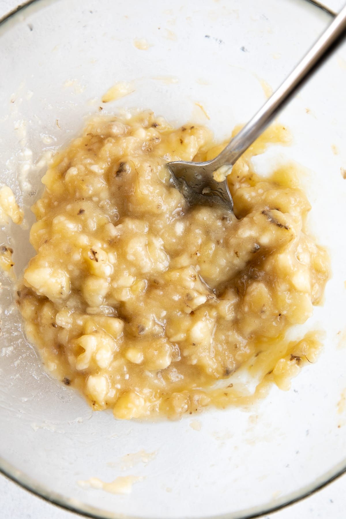Glass bow filled with mashed ripe bananas.