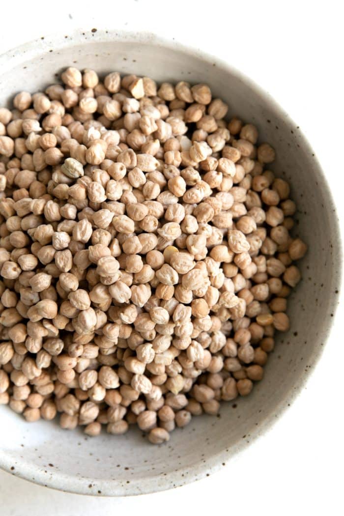 Large shallow bowl filled with dry chickpeas.