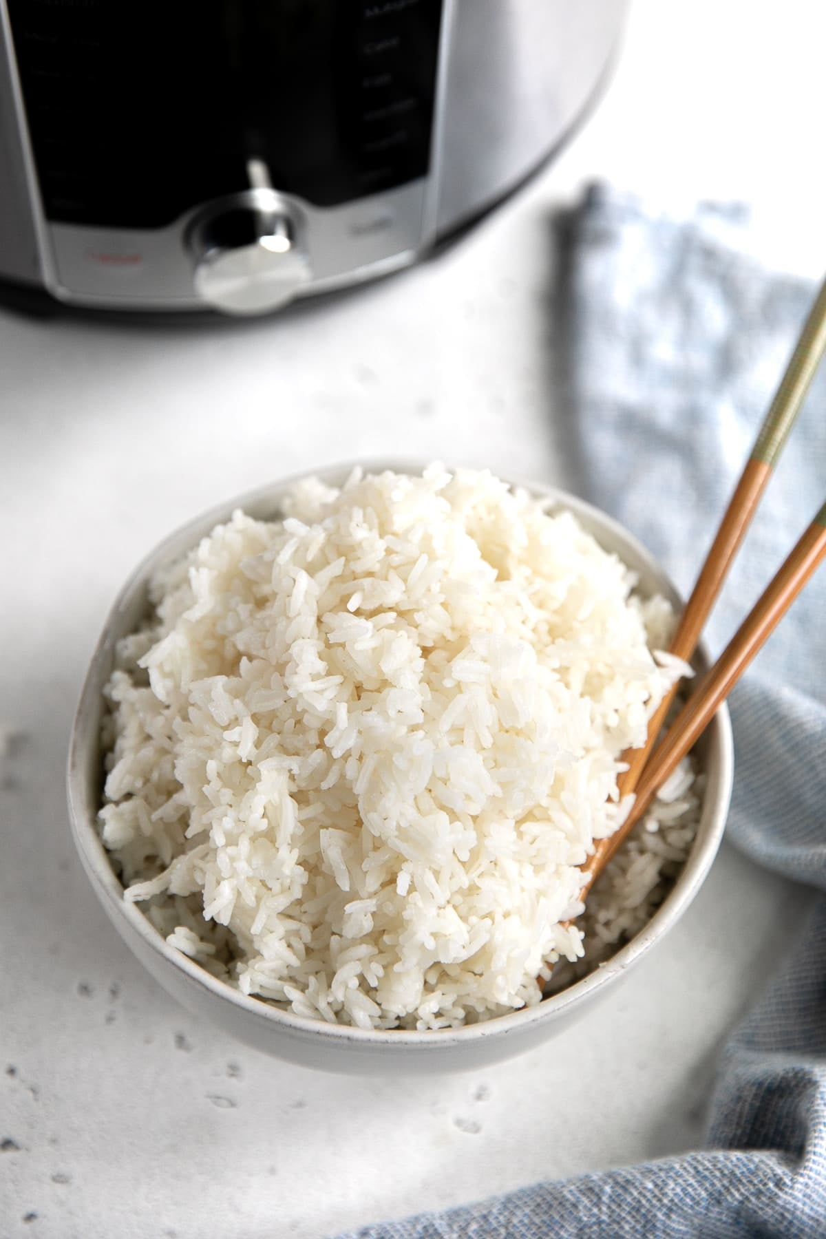 Small white bowl filled with Instant Pot cooked rice.