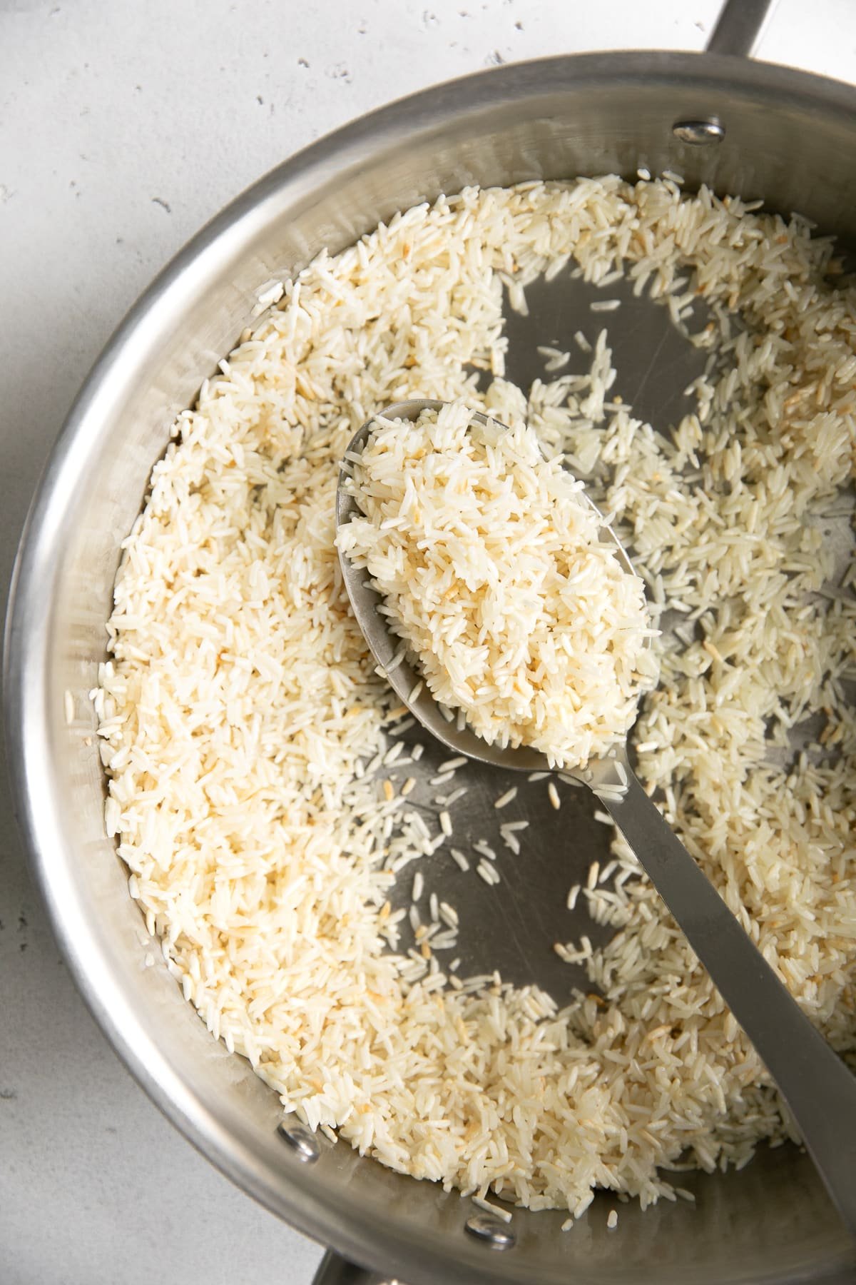 Cooking jasmine rice in butter before cooking.