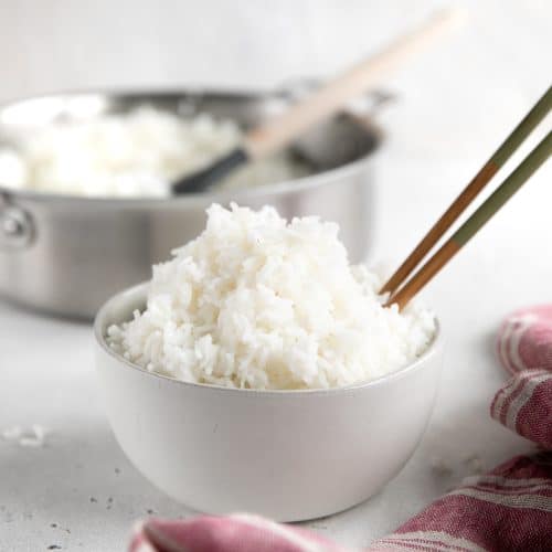 White bowl filled with perfectly fluffy white rice.