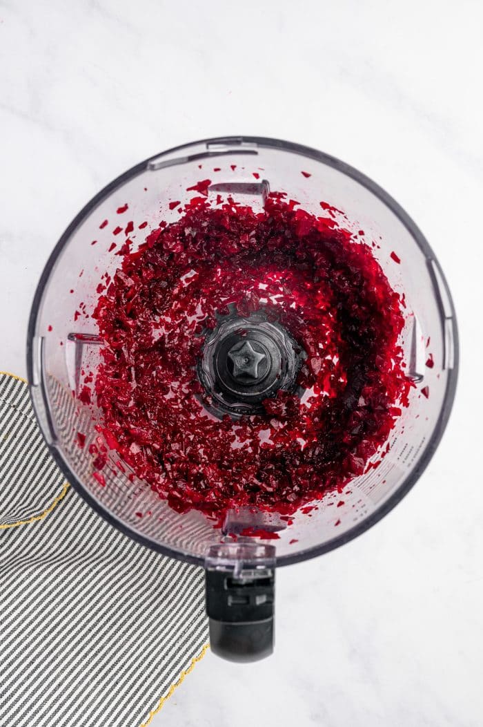 Chopped beets inside a food processor after pulsing