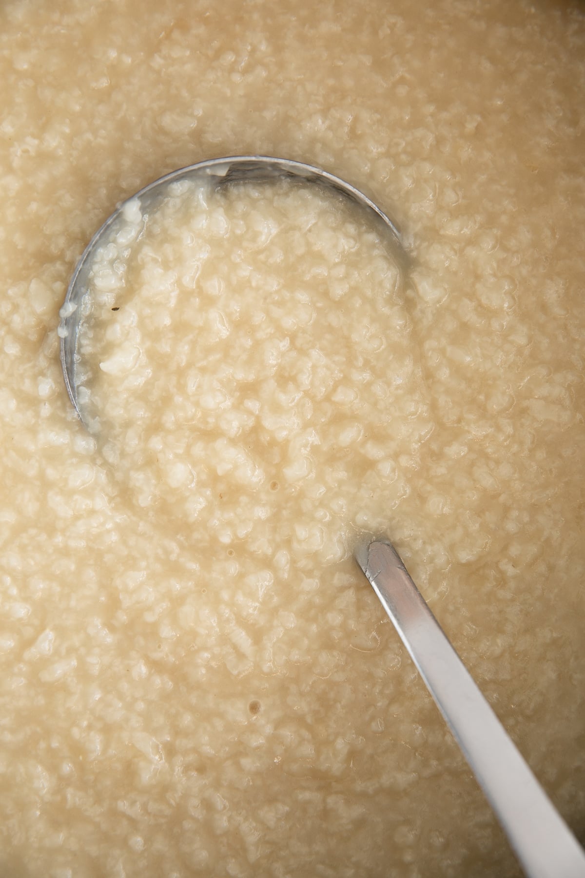 Cooked congee in a large pot.