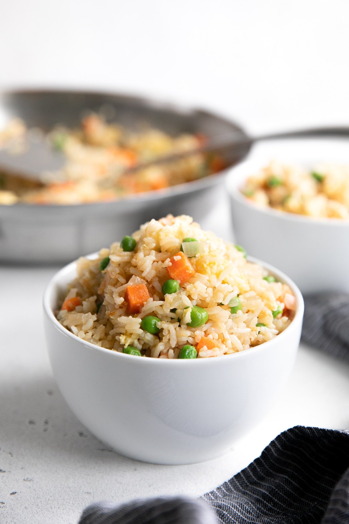 Small white bowl filled with fried rice.