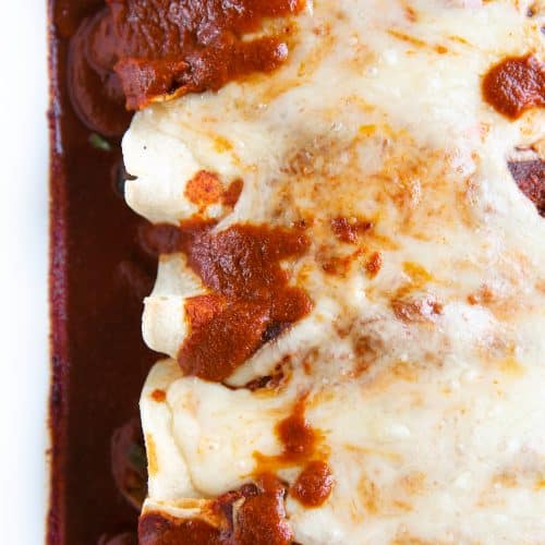 Enchiladas filled with mixed veggies, rolled in corn tortillas, topped with cheese and baked.