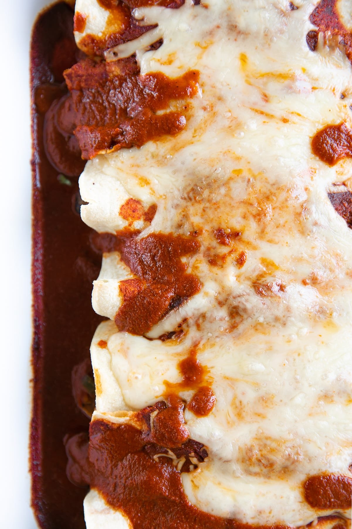 Enchiladas filled with mixed veggies, rolled in corn tortillas, topped with cheese and baked.