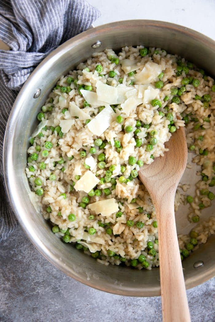 Pan filled with cooked arborio rice (risotto) with peas and parmesan.