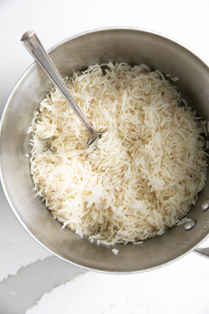 small pot filled with cooked white basmati rice.
