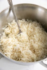 Fluffing a pot of white basmati rice.