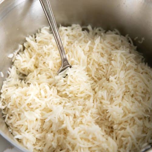 Fluffing a pot of white basmati rice.
