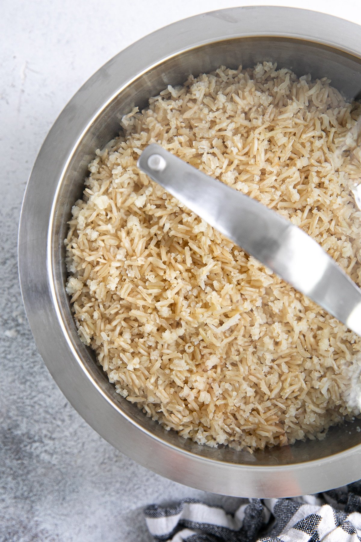 Cooked brown rice steaming in a pot.