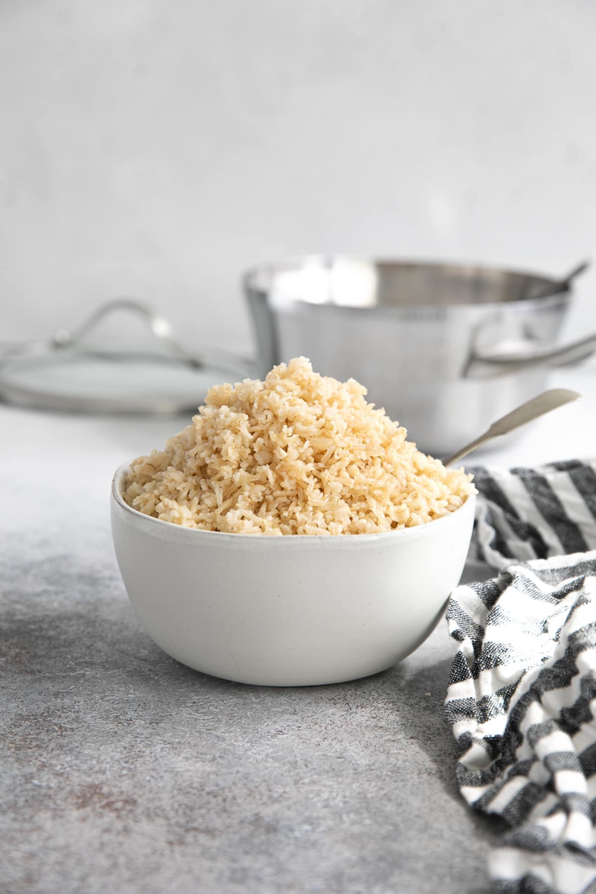 White bowl filled with perfectly cooked brown rice.