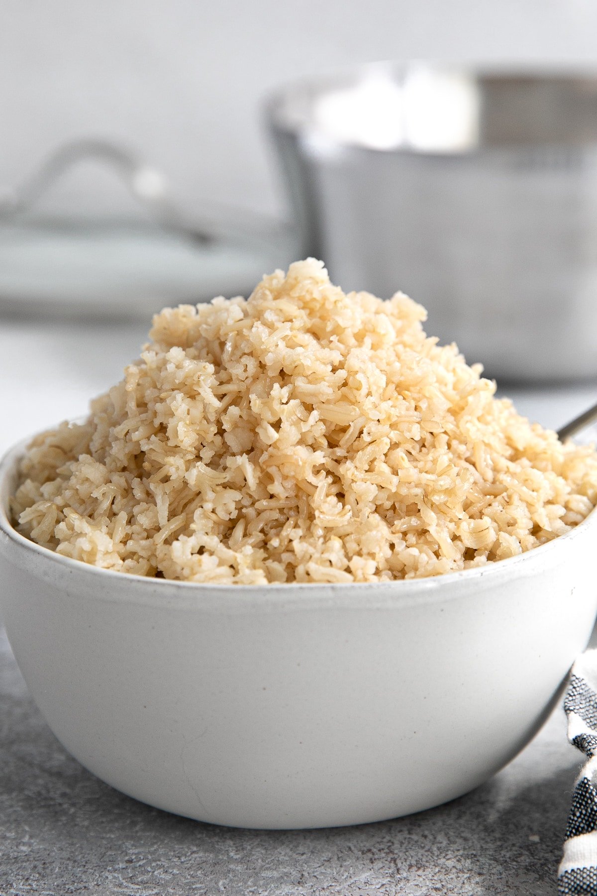White bowl filled with perfectly cooked brown basmati rice.