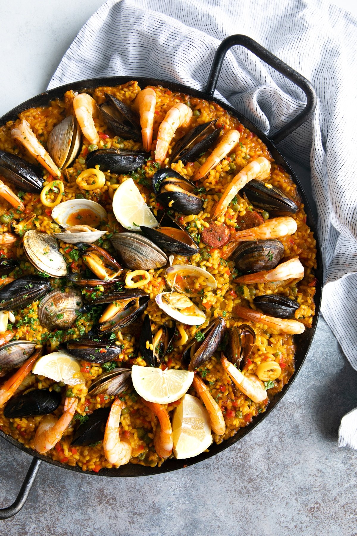Seafood and sausage Spanish paella in a large cast iron paella pan.