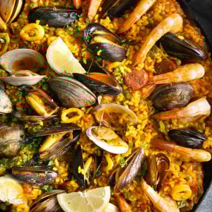 Paella filled with mussels, clams, shrimp, calamari, spanish chorizo, and saffron rice.