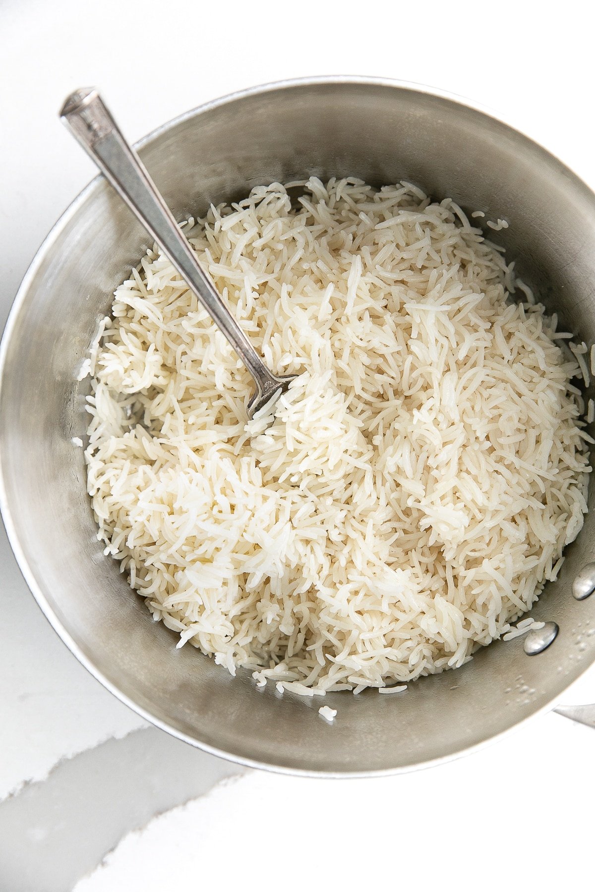 Perfectly cooked and fluffed basmati rice in a small pot
