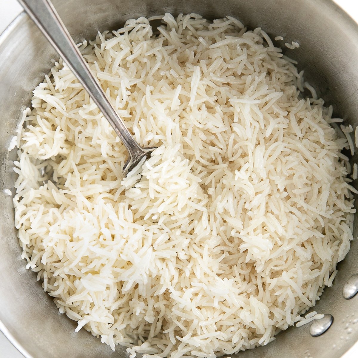 Perfectly cooked and fluffed basmati rice in a small pot