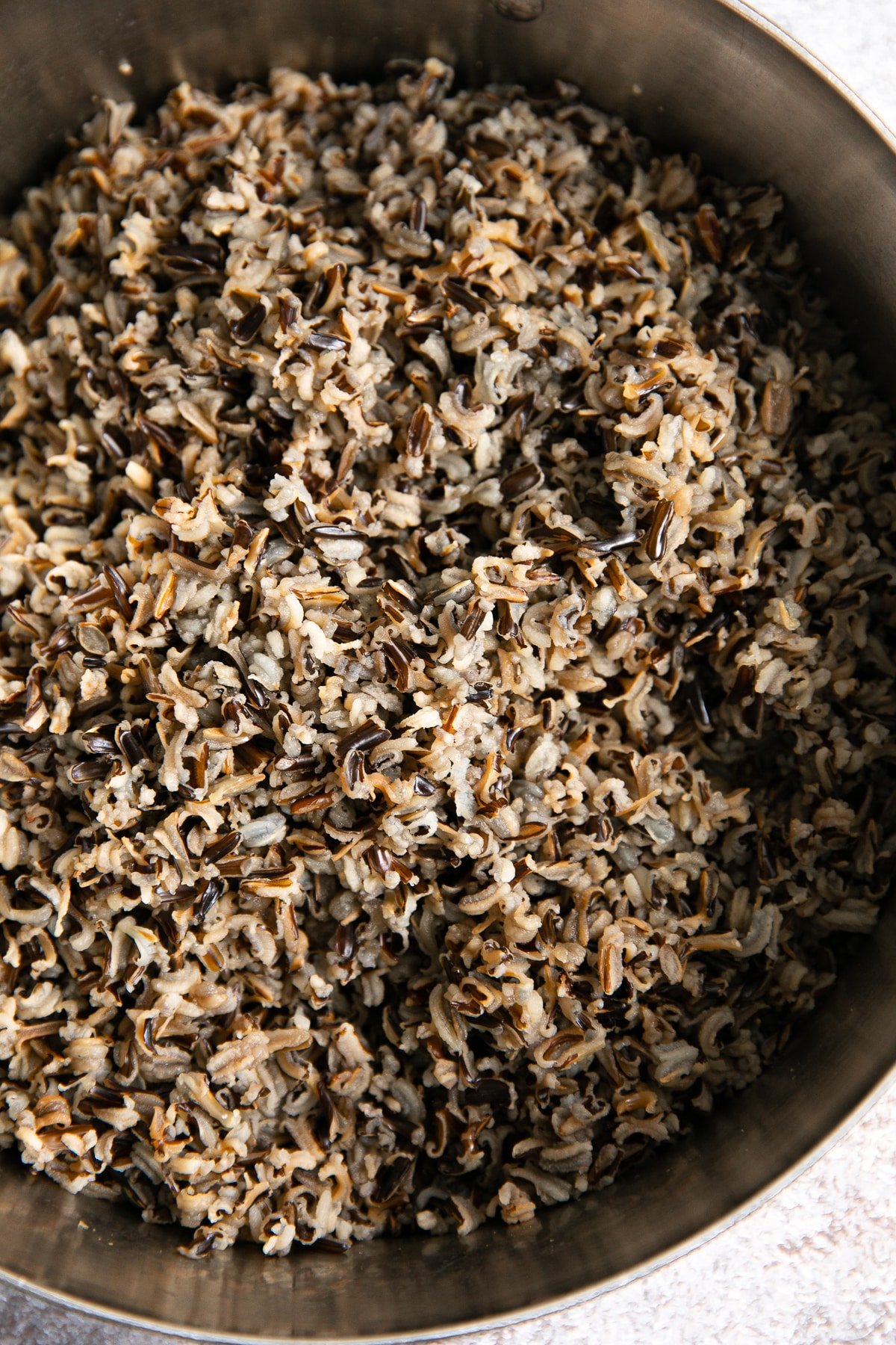 Pot filled with cooked wild rice.