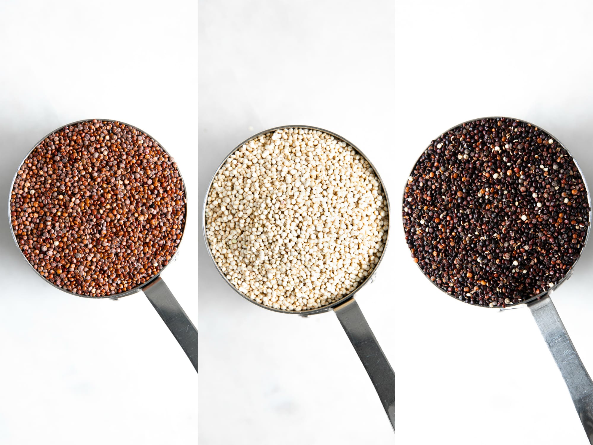 Measuring cups filled with different colored quinoa.