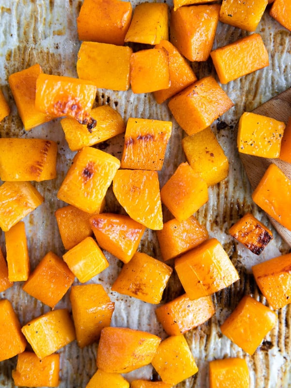 Roasted butternut squash on a large baking sheet.