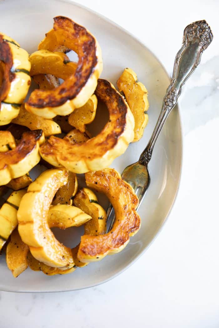 White platter filled with simply seasoned delicata squash