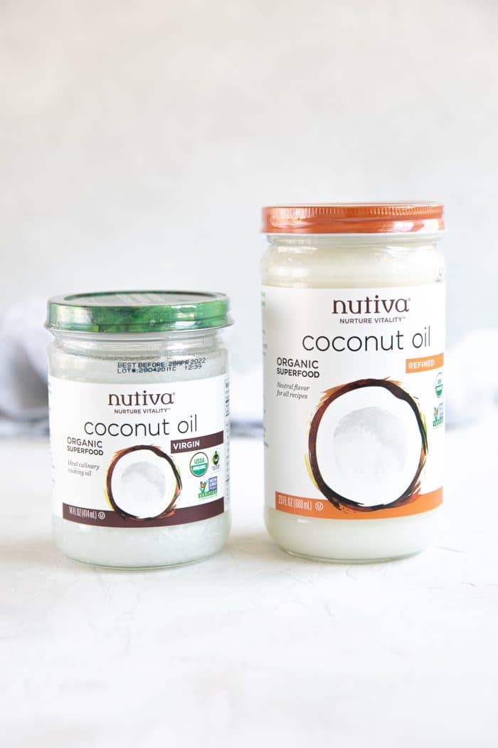 Two jars of coconut oil, one that is refined, and one that is not refined.