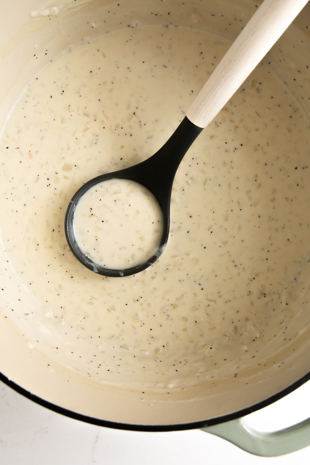 Dutch oven filled with homemade cream sauce