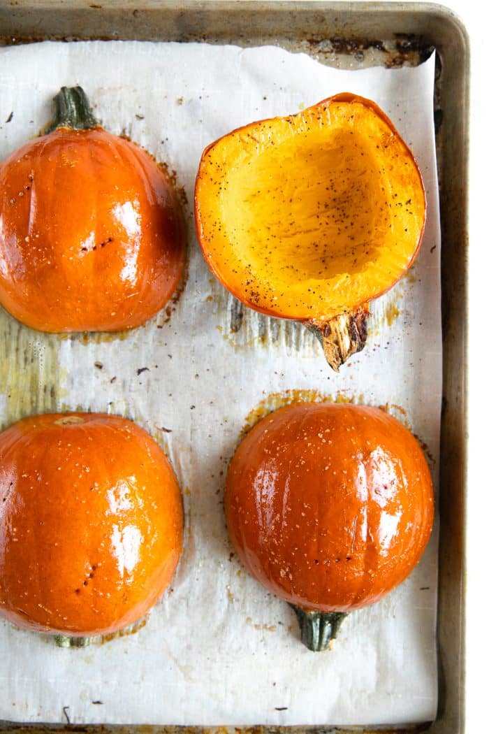 Two halved sugar pumpkins roasted in the oven